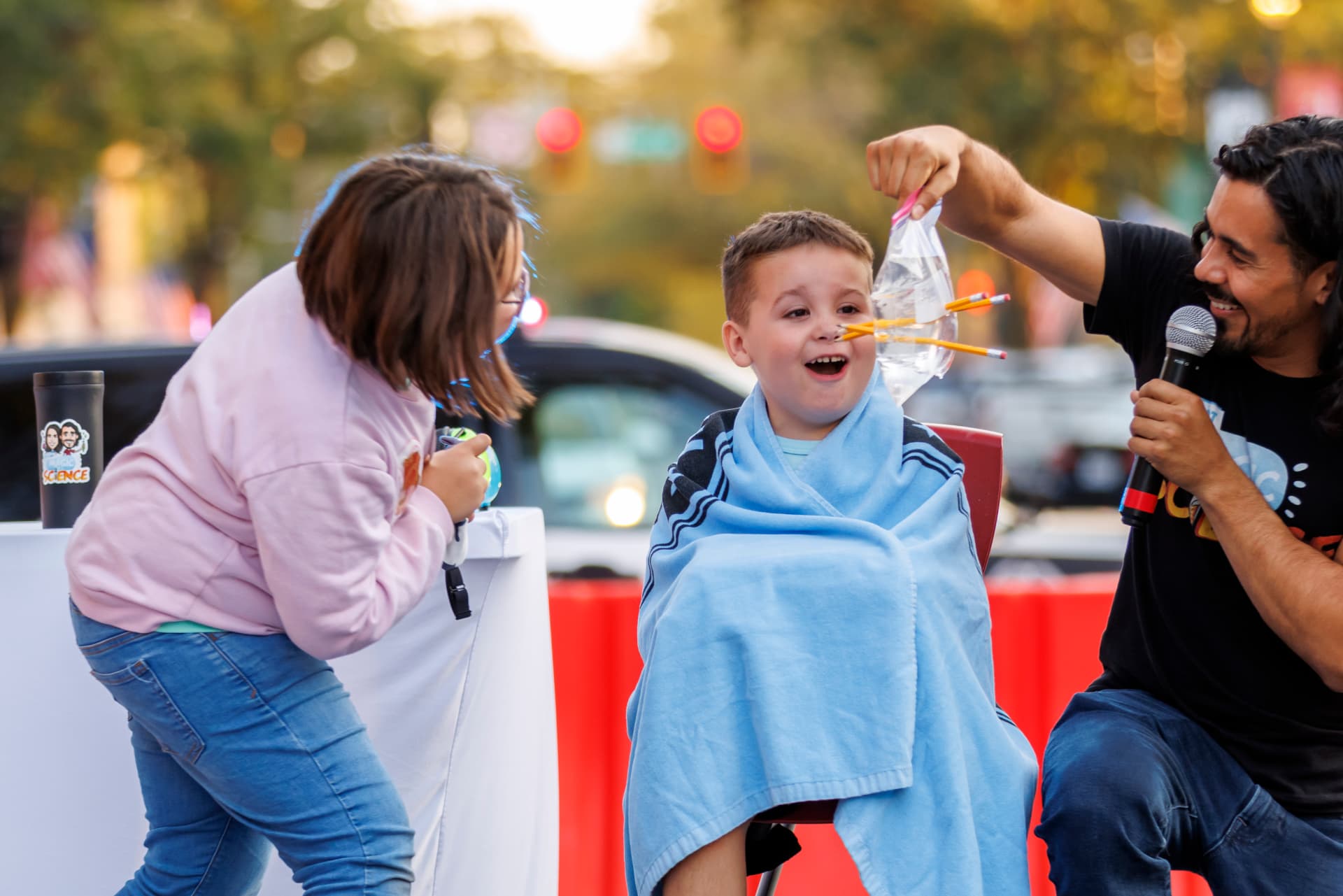 Jay Flores leading a live science demonstration with a young participant